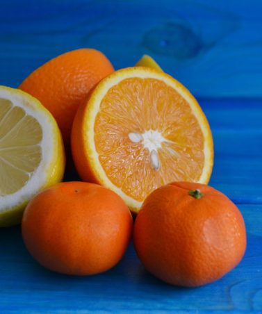 Oranges on Blue Table Providing Vitamin C Boost
